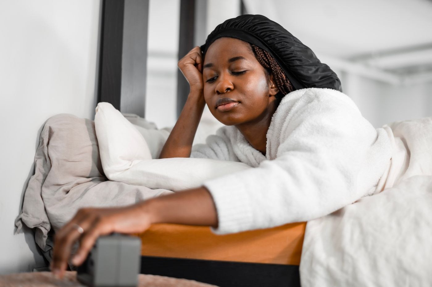 Woman Turning off Alarm Clock