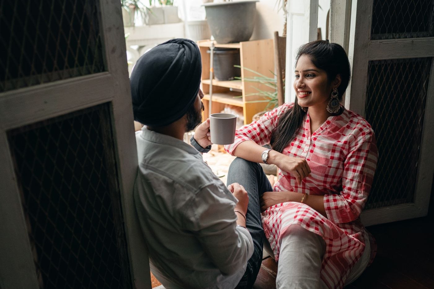 Happy couple talking at home at weekend