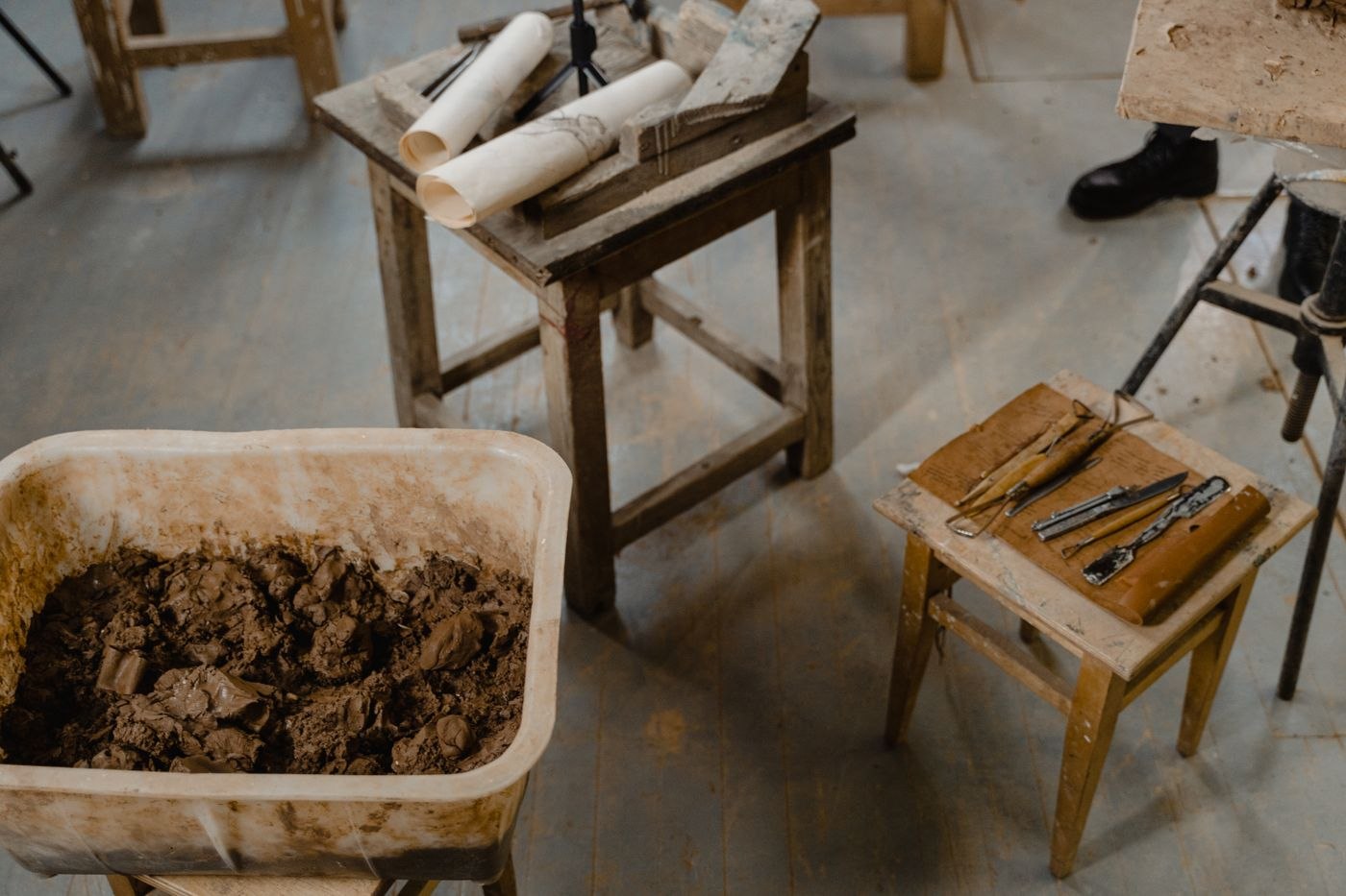Tools and Materials On Wooden Chair and Table In A Workspace