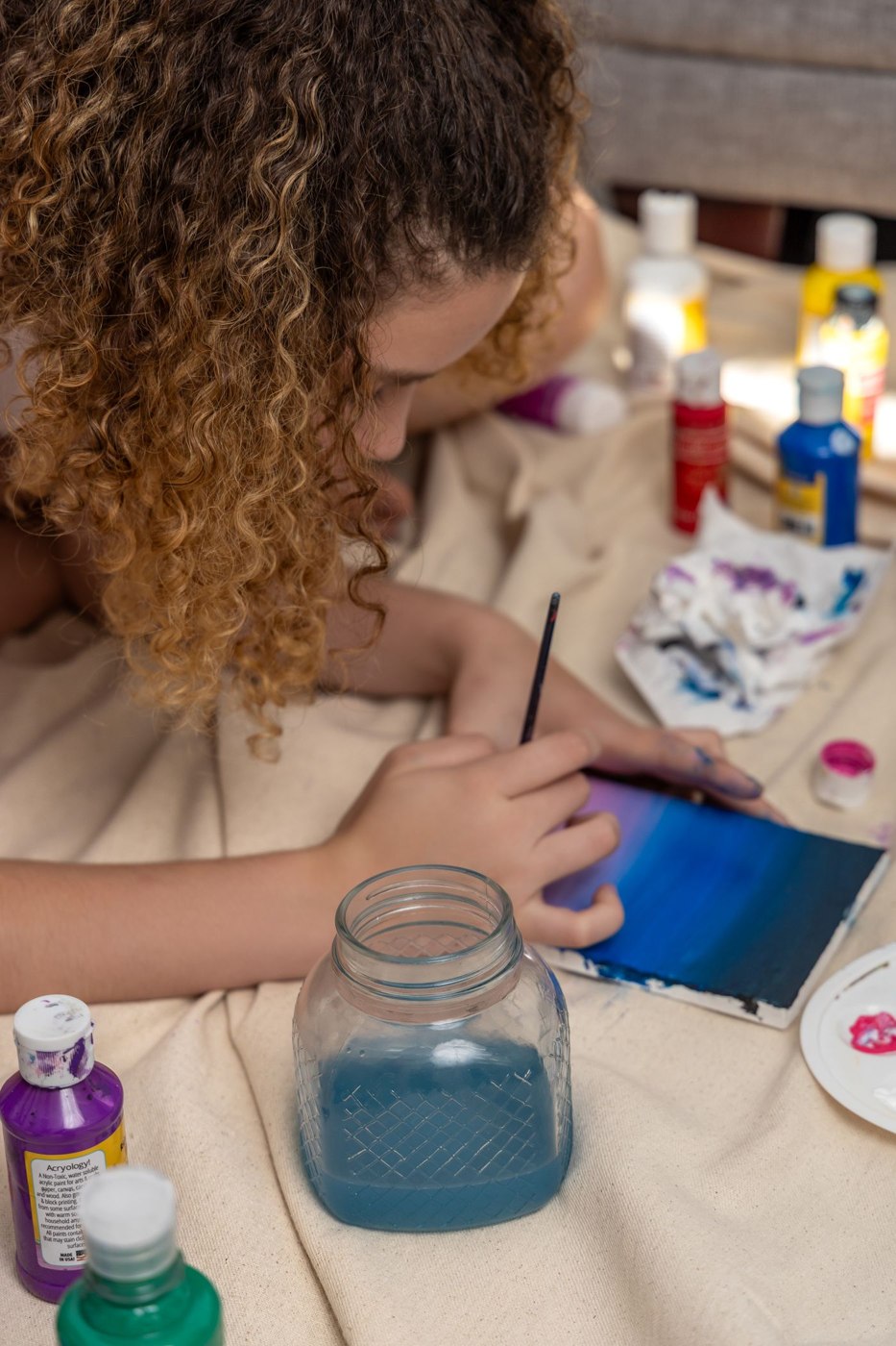 Woman Engaged in Creative Painting Session at Home