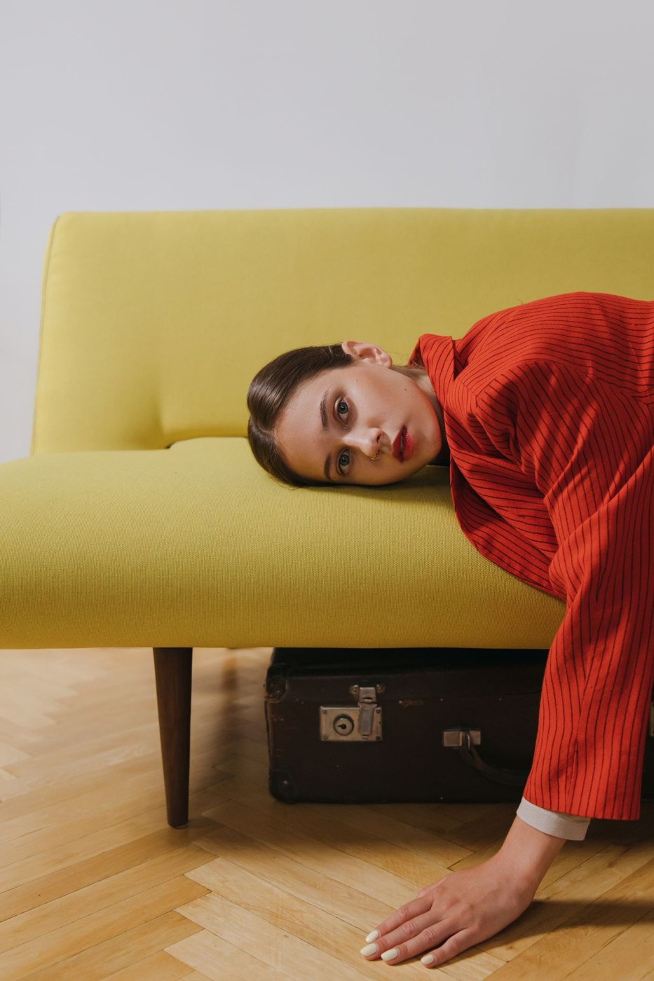 A Tired Woman Resting on a Couch