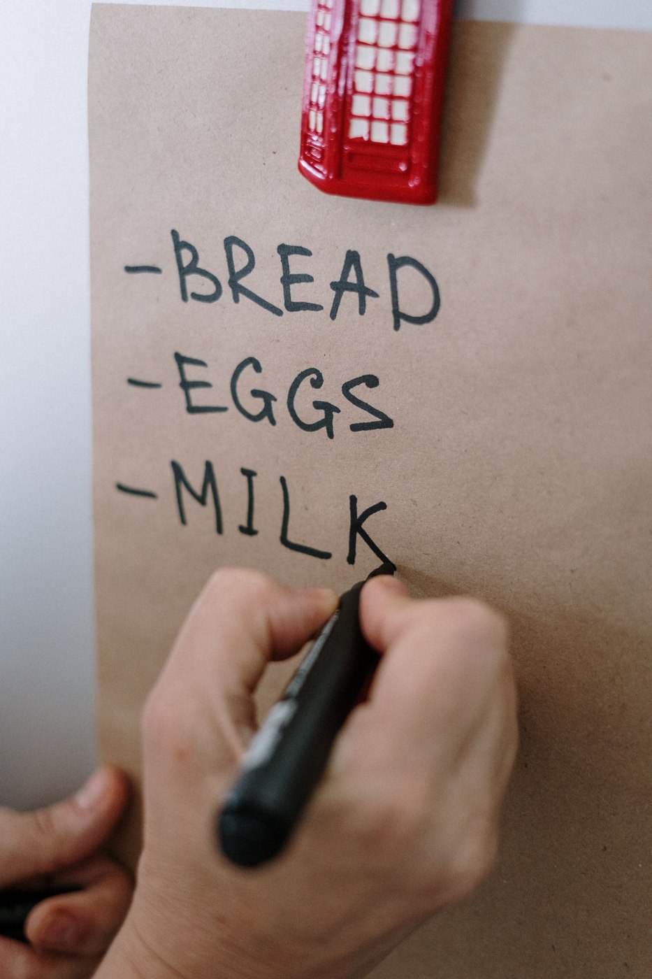Handwriting a Shopping List on Brown Paper