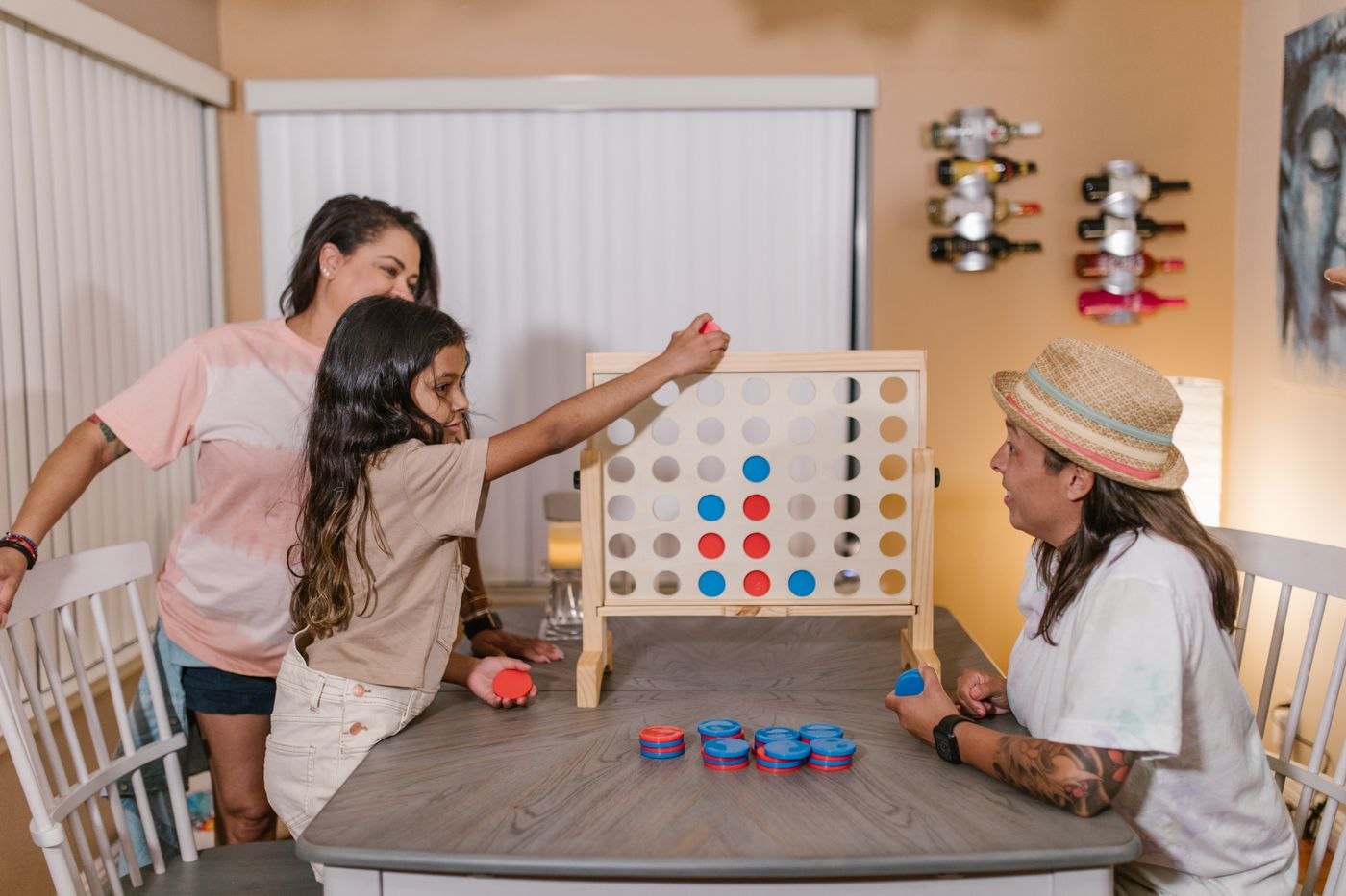 A family playing a four-in-a-row board game together
