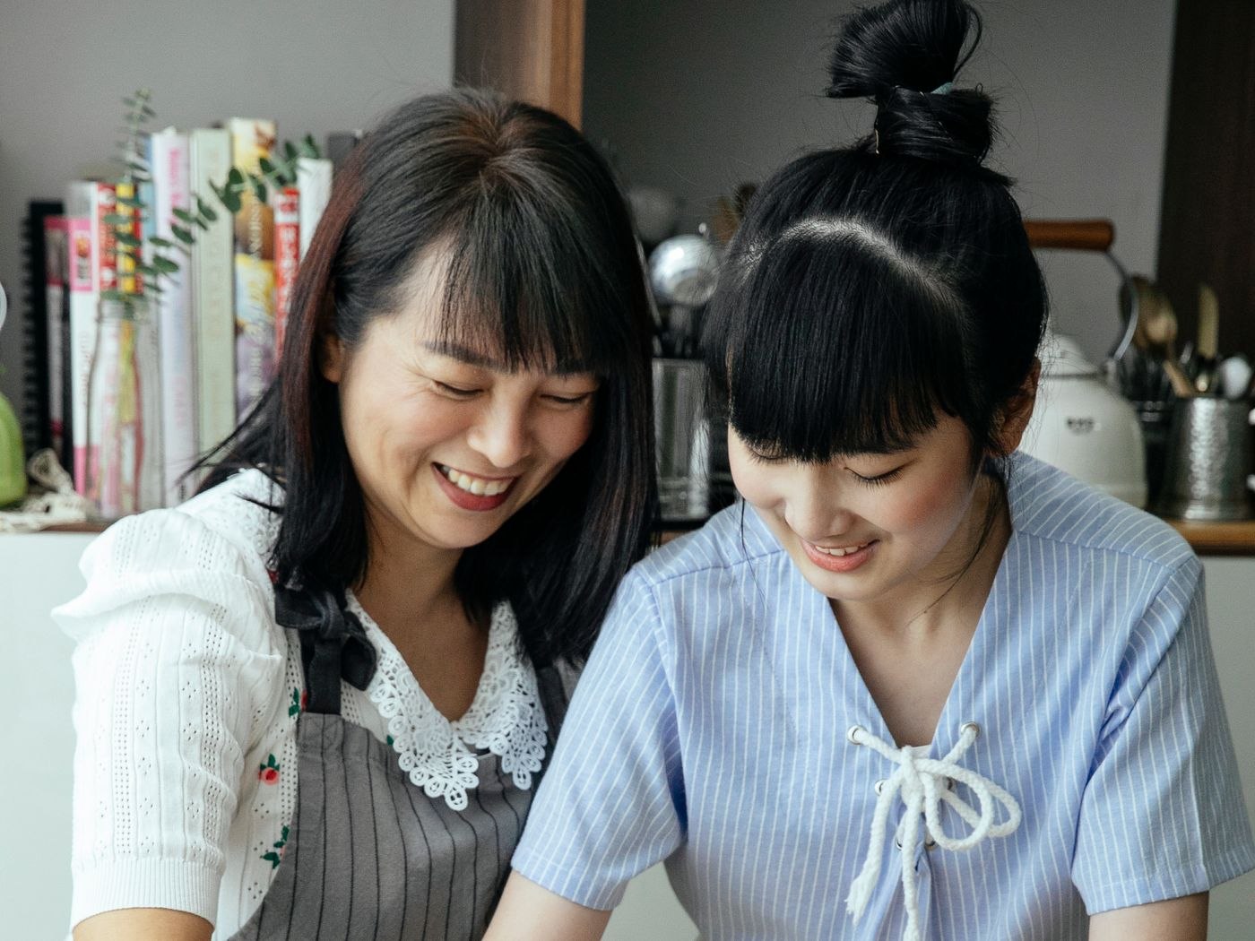 Two people preparing food together in a kitchen